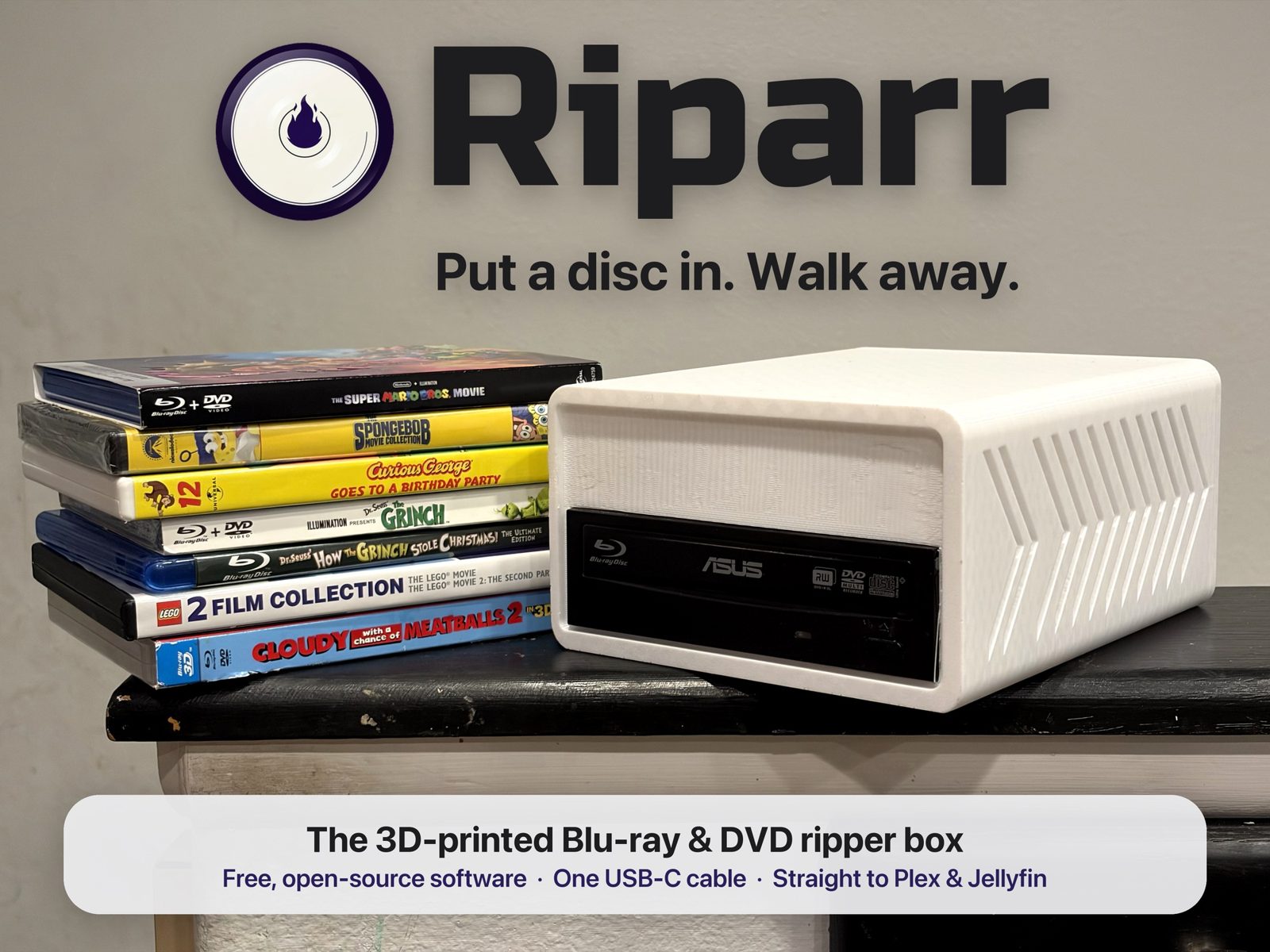 Riparr, a 3D printed Blu-ray and DVD ripper box in white PETG with an ASUS drive, beside a stack of Blu-ray and DVD cases