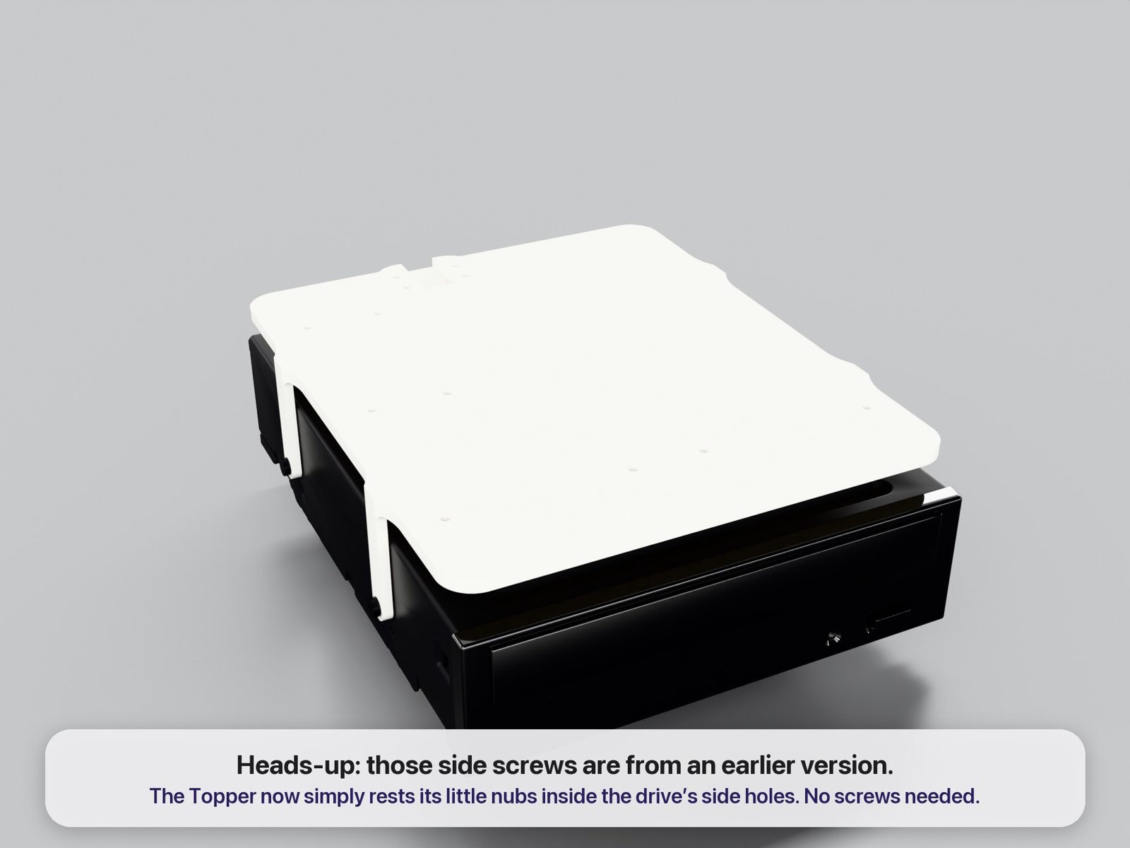 The Power Topper resting on top of a full-size 5.25 inch optical drive by its side nubs